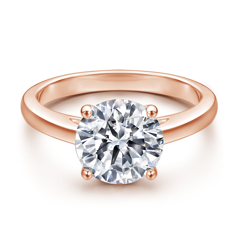 Rose gold ring with a diamond on a white background