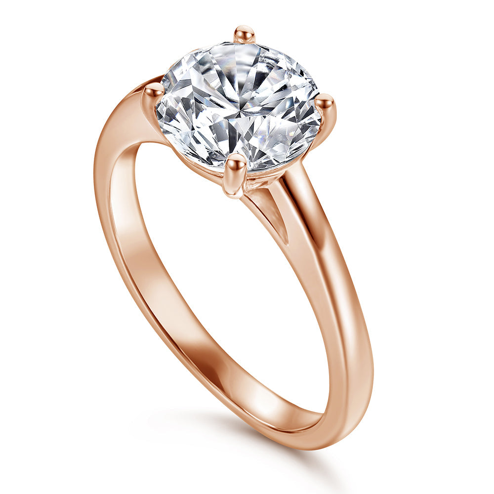 Rose gold ring with a large diamond on a white background
