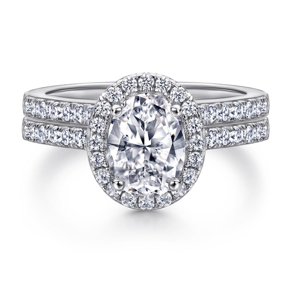 Diamond ring with a central gemstone and surrounding diamonds on a white background