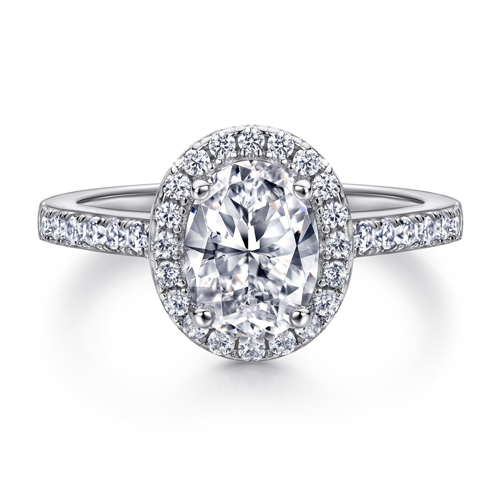Diamond ring with a halo on a white background