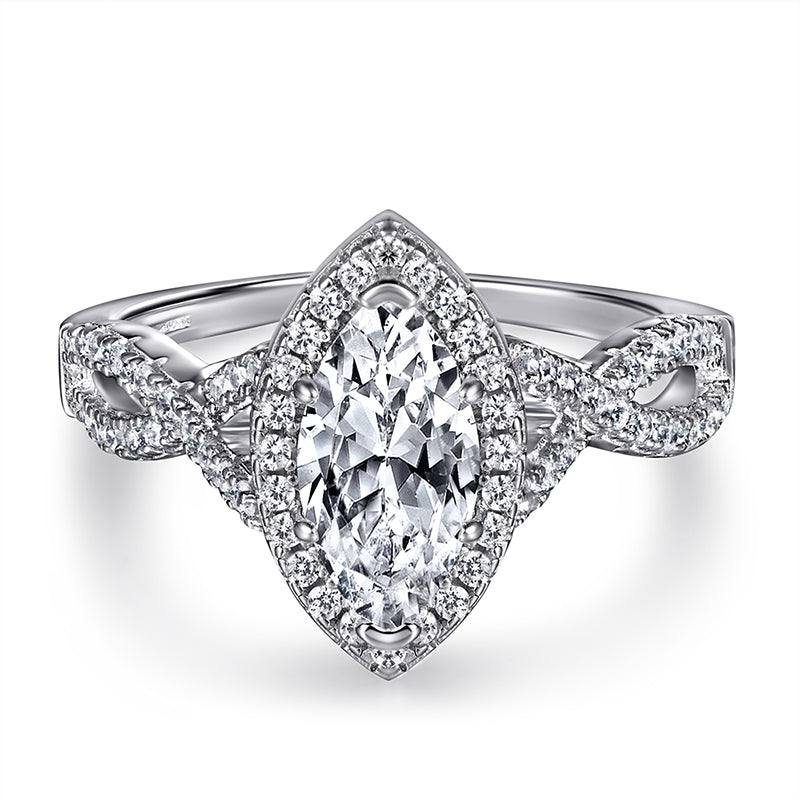 Silver ring with a central diamond and intricate design on a white background