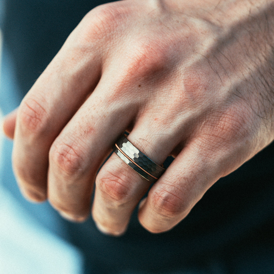 Close-up of a hand wearing a ring with a blurred background