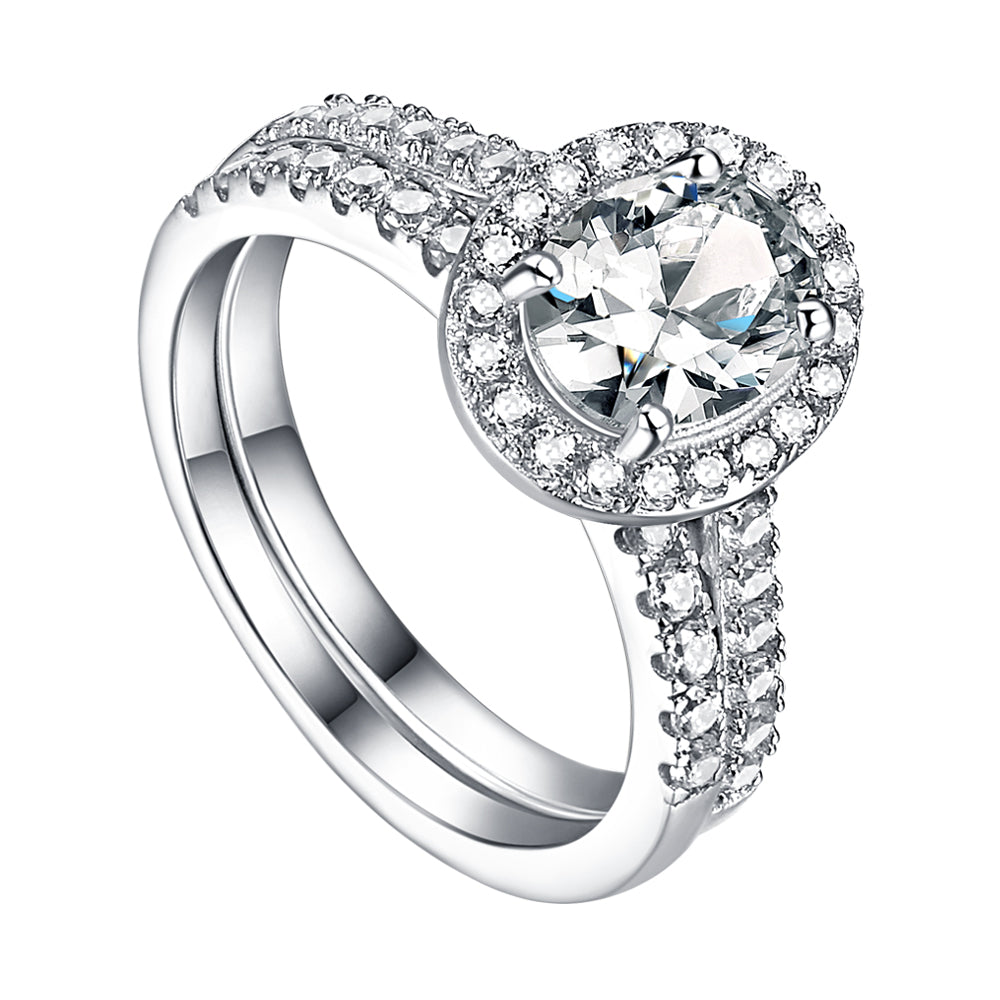 Silver ring with a large central gemstone and smaller stones on a white background