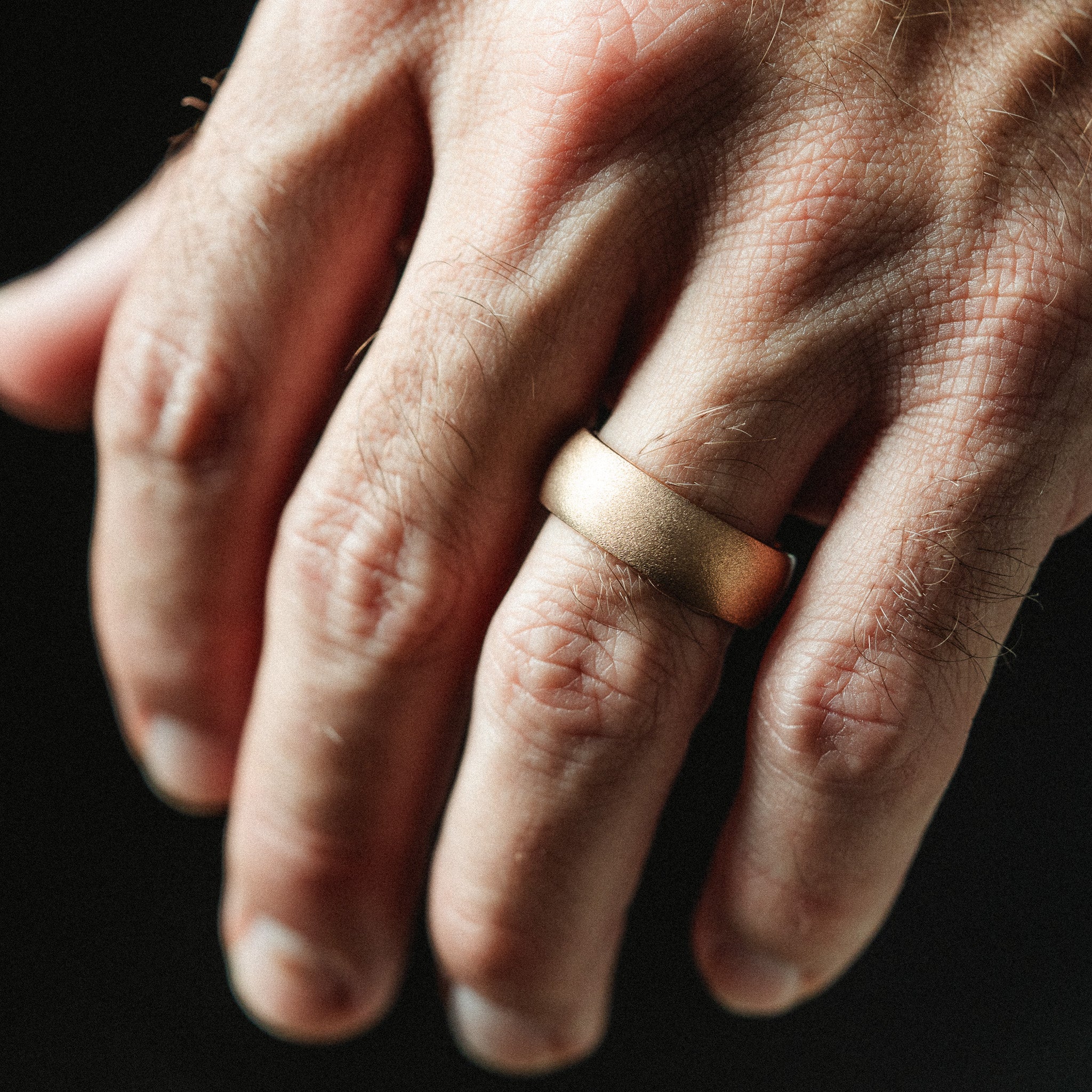 rose gold ring on mans hand