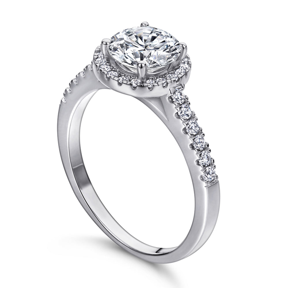 Diamond ring with a halo and smaller diamonds on a white background