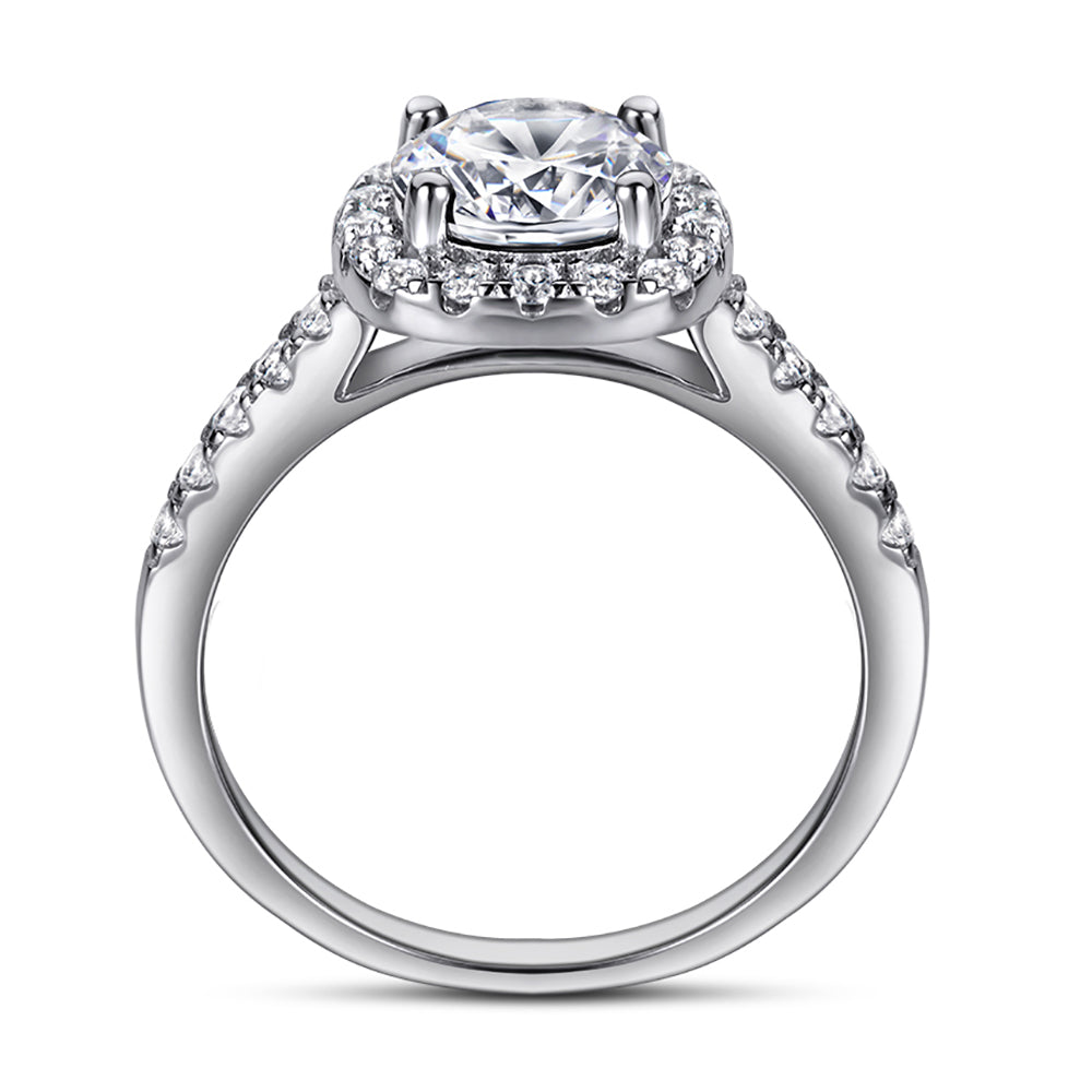 Silver ring with a large central diamond and smaller diamonds on the band against a white background