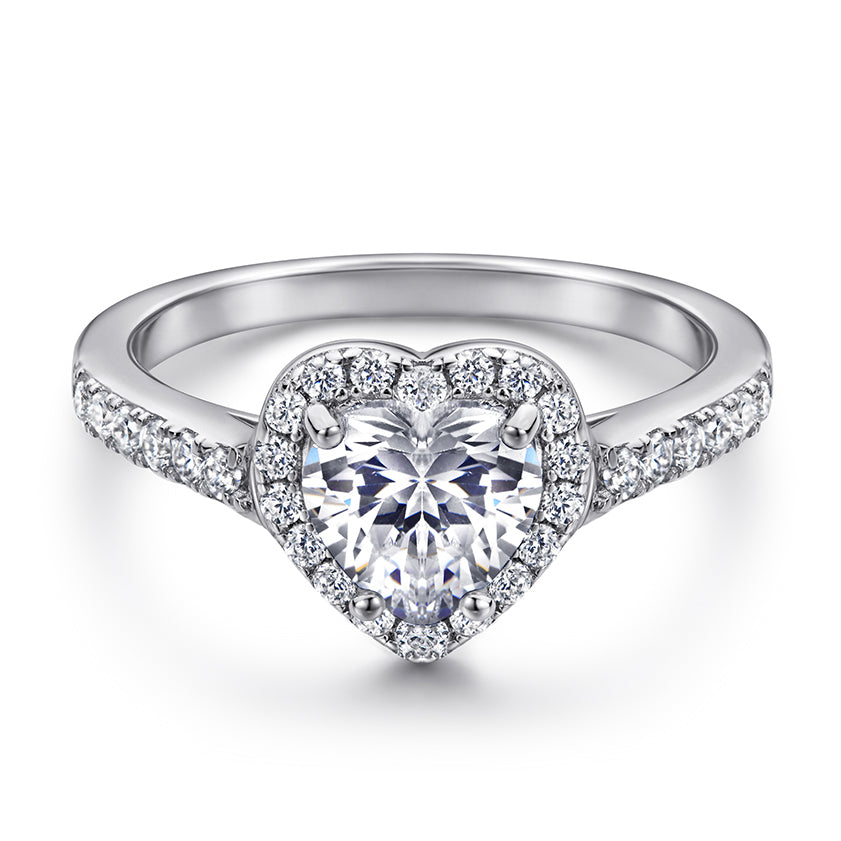 Heart-shaped diamond ring with a white background