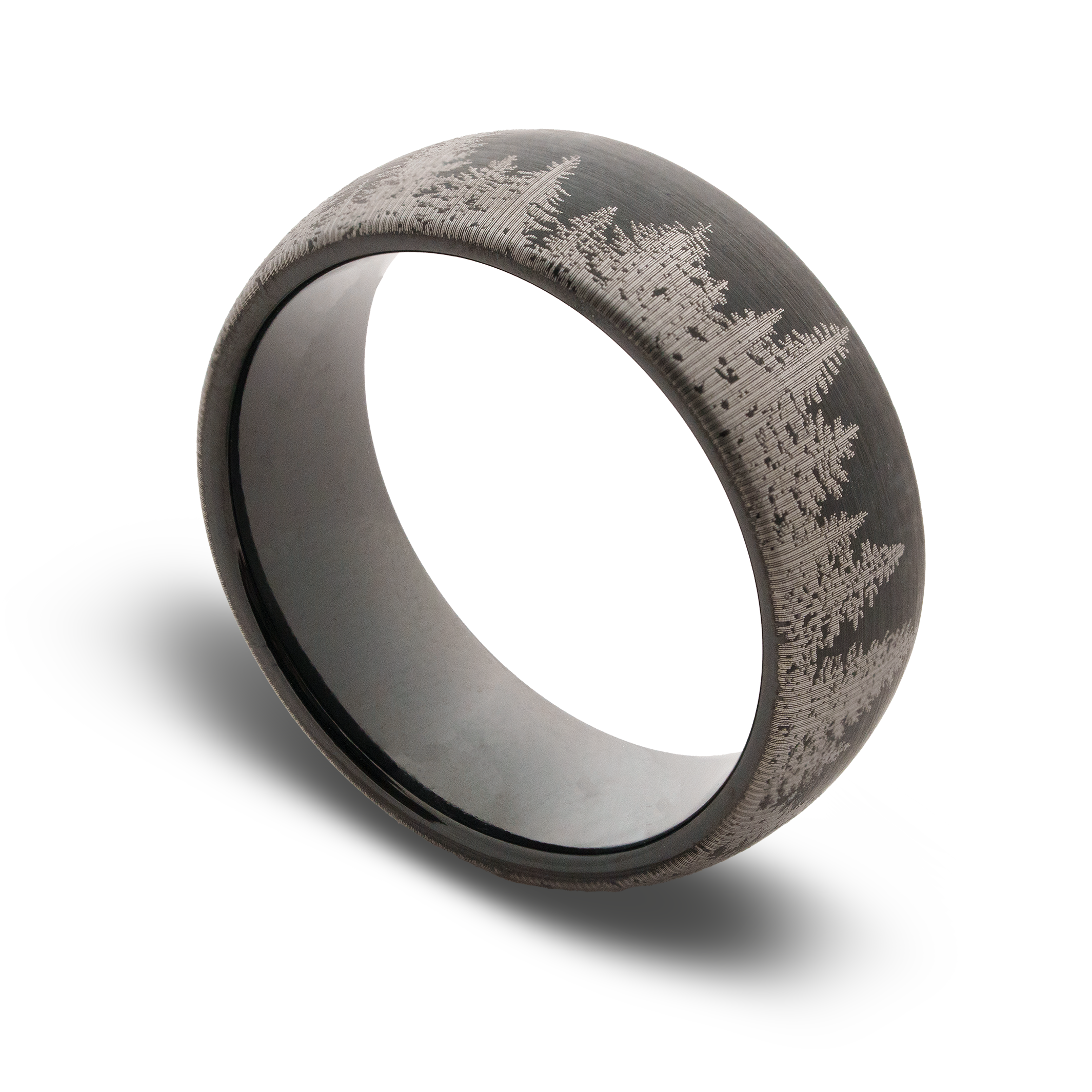 Black ring with engraved design on a white background
