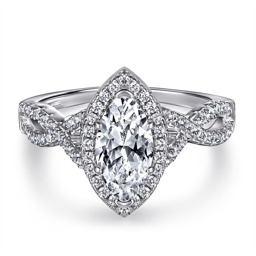 Diamond ring with a marquise-shaped center stone on a white background