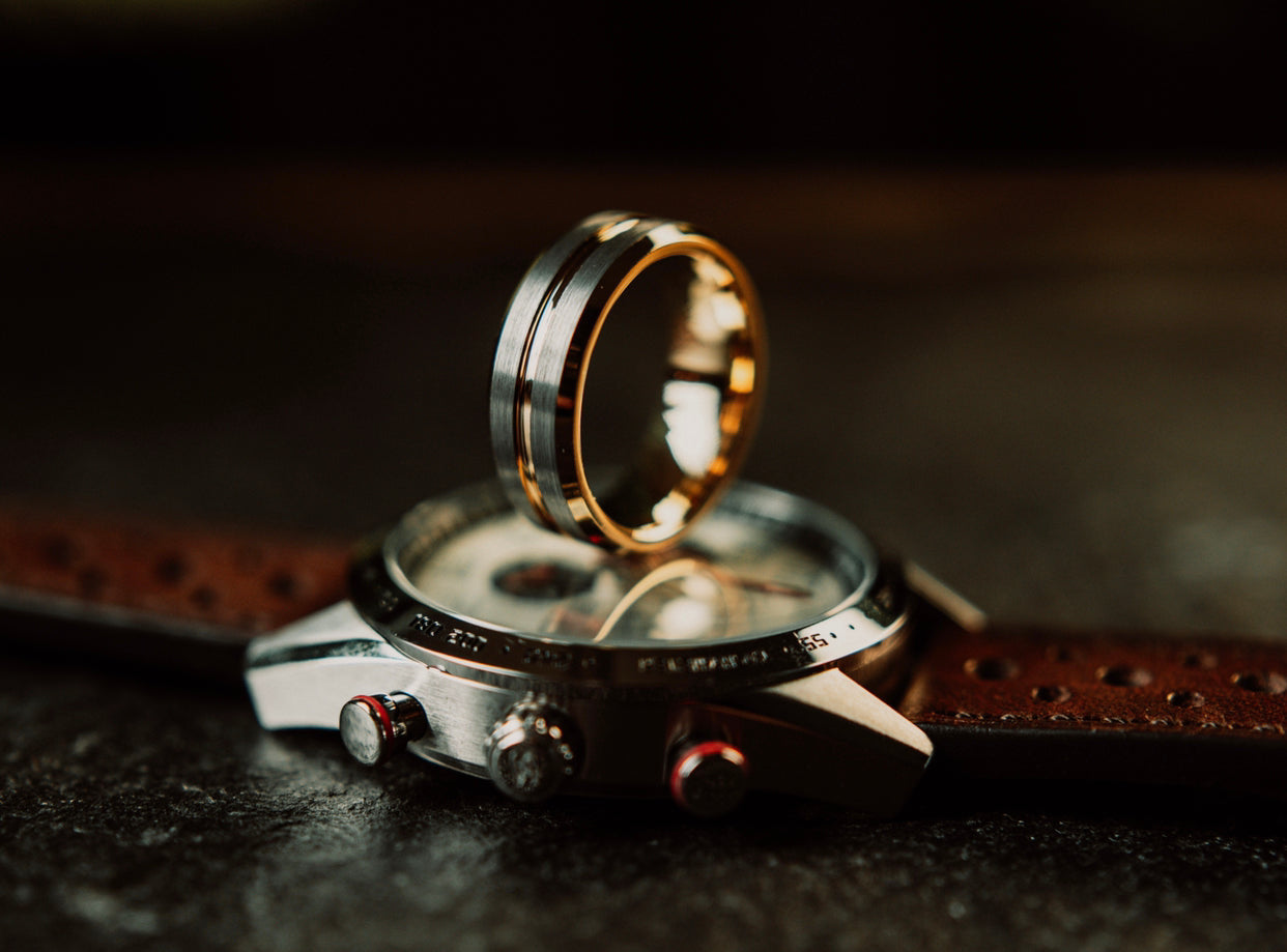 Gold ring on a wristwatch with a dark background