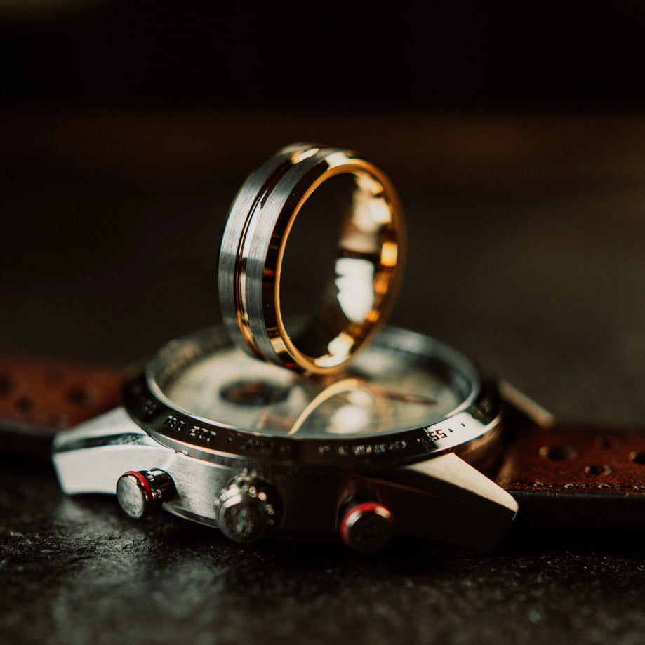 Gold ring on a wristwatch with a dark background