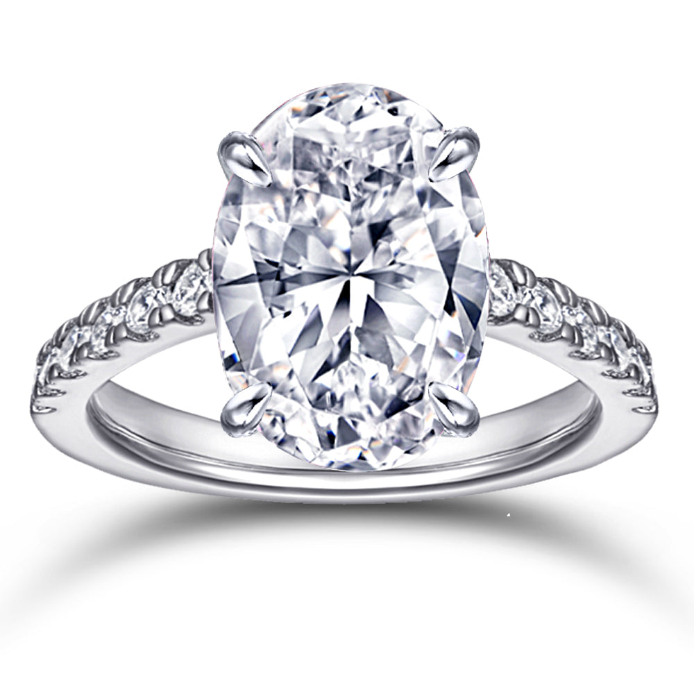Diamond ring with a pear-shaped center stone on a white background