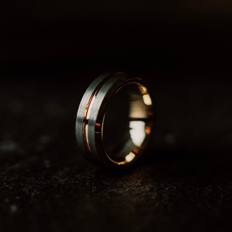 Gold ring on a dark textured surface