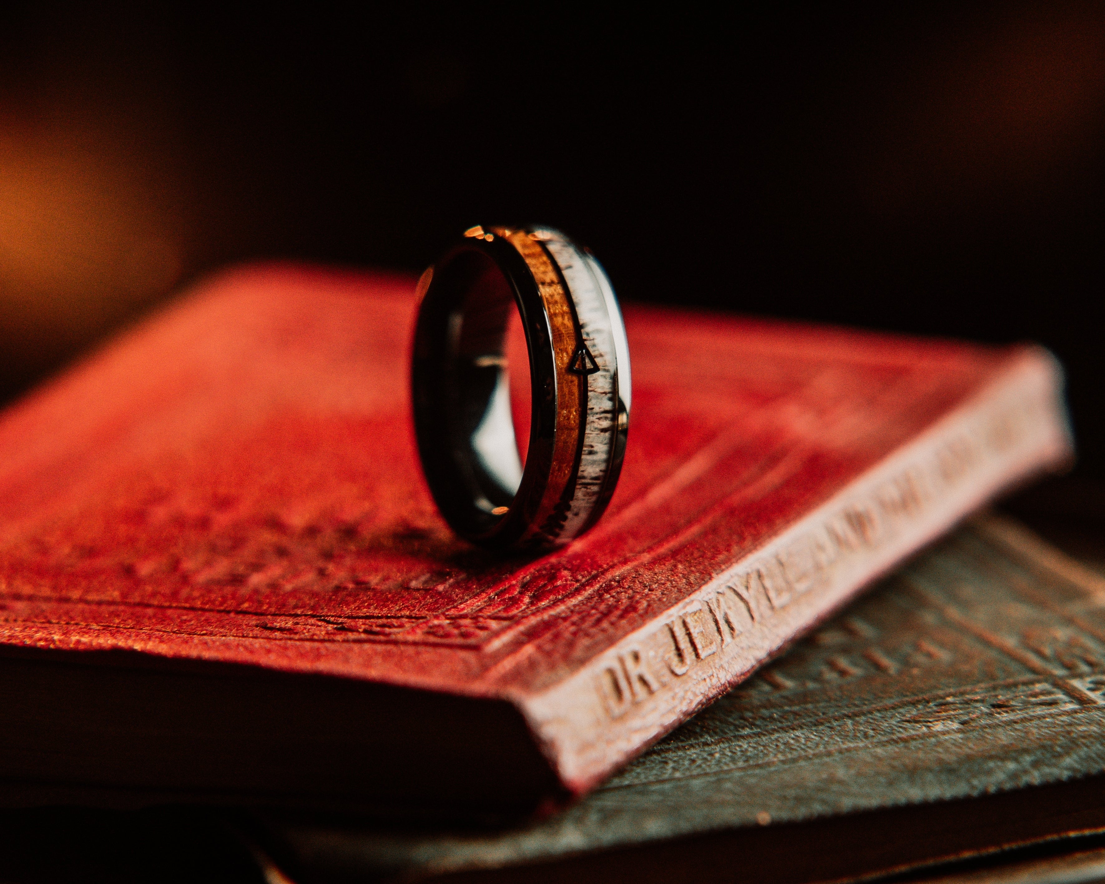 Wooden ring on a red leather-bound book with a blurred background