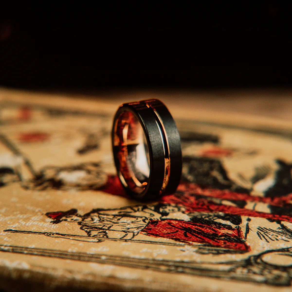 Gold and black ring on an old map