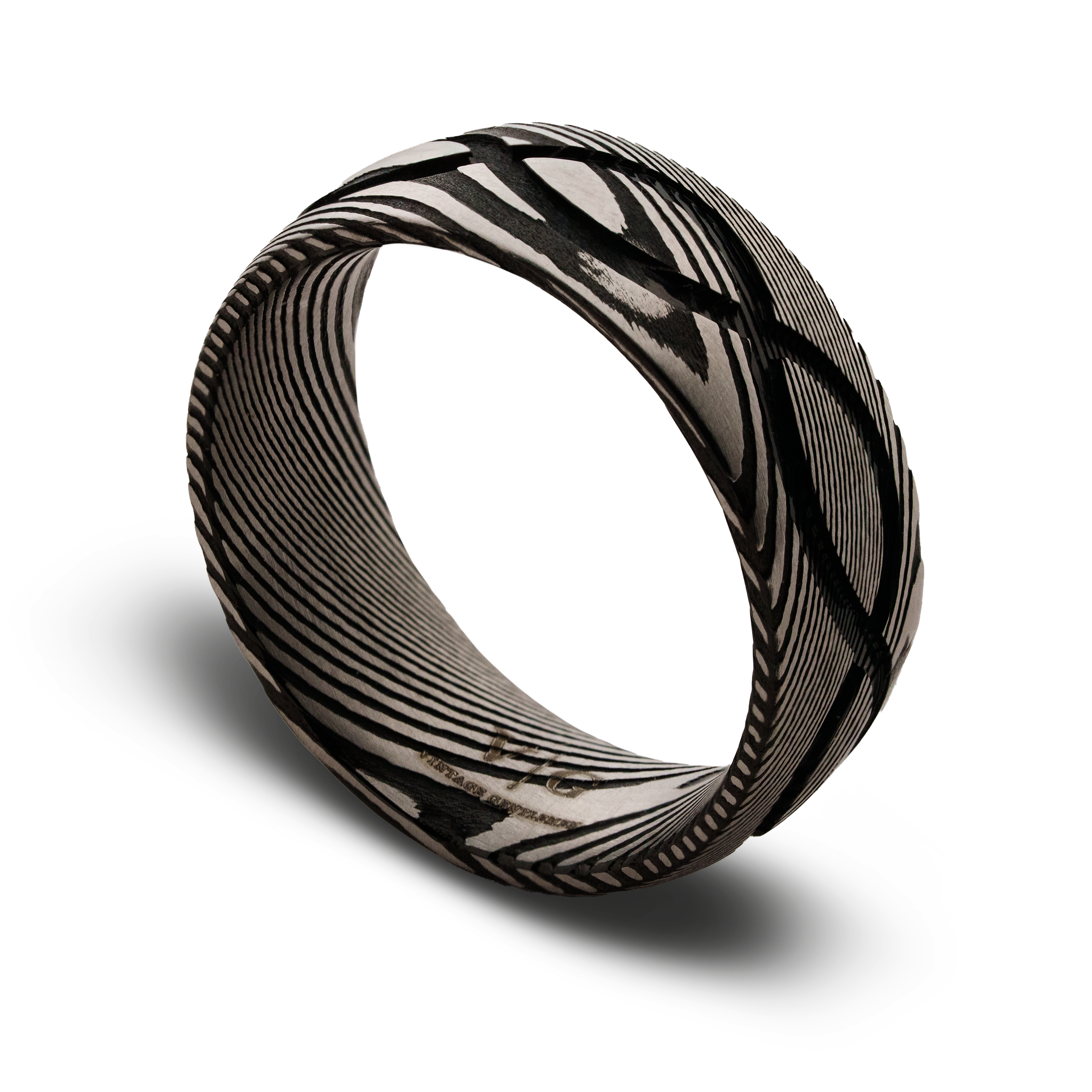 Black and silver patterned ring on a white background