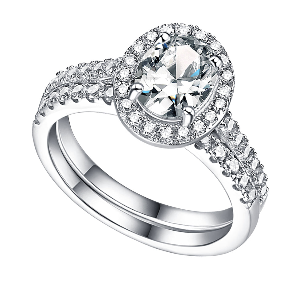 Silver ring with a large central gemstone and smaller stones on a white background