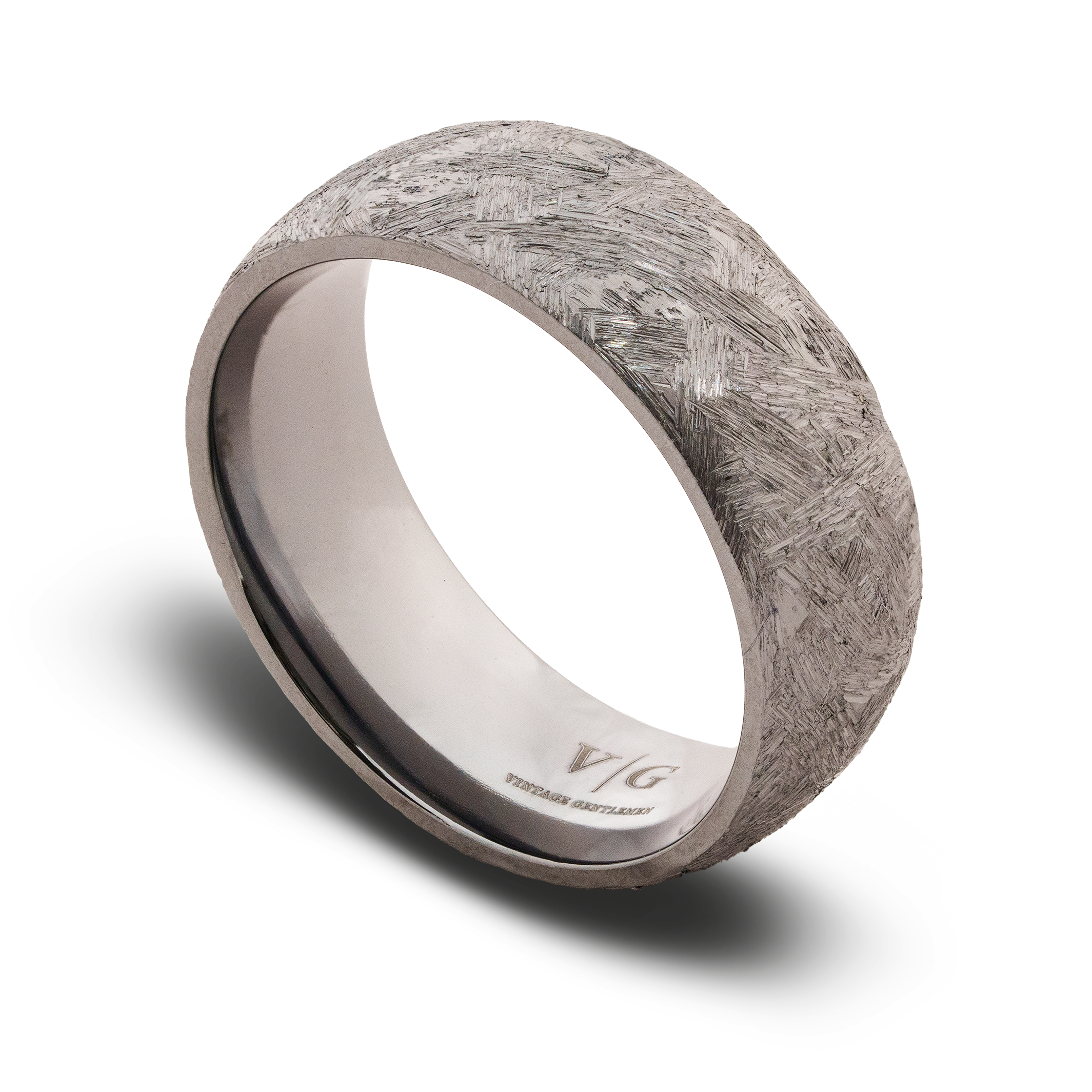 Silver ring with textured surface on a white background