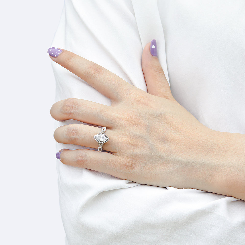 Hand wearing a diamond ring with a white background
